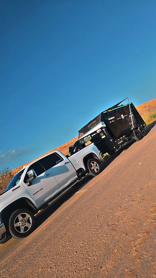 Pete Martinez's truck and Outlaw Haulin dump trailer on a caliche road outside Amarillo, Texas